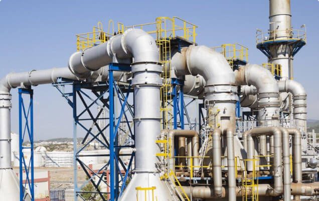 Petrochemical processing plant with pipework and distillation towers